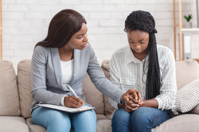 therapist talking to young woman